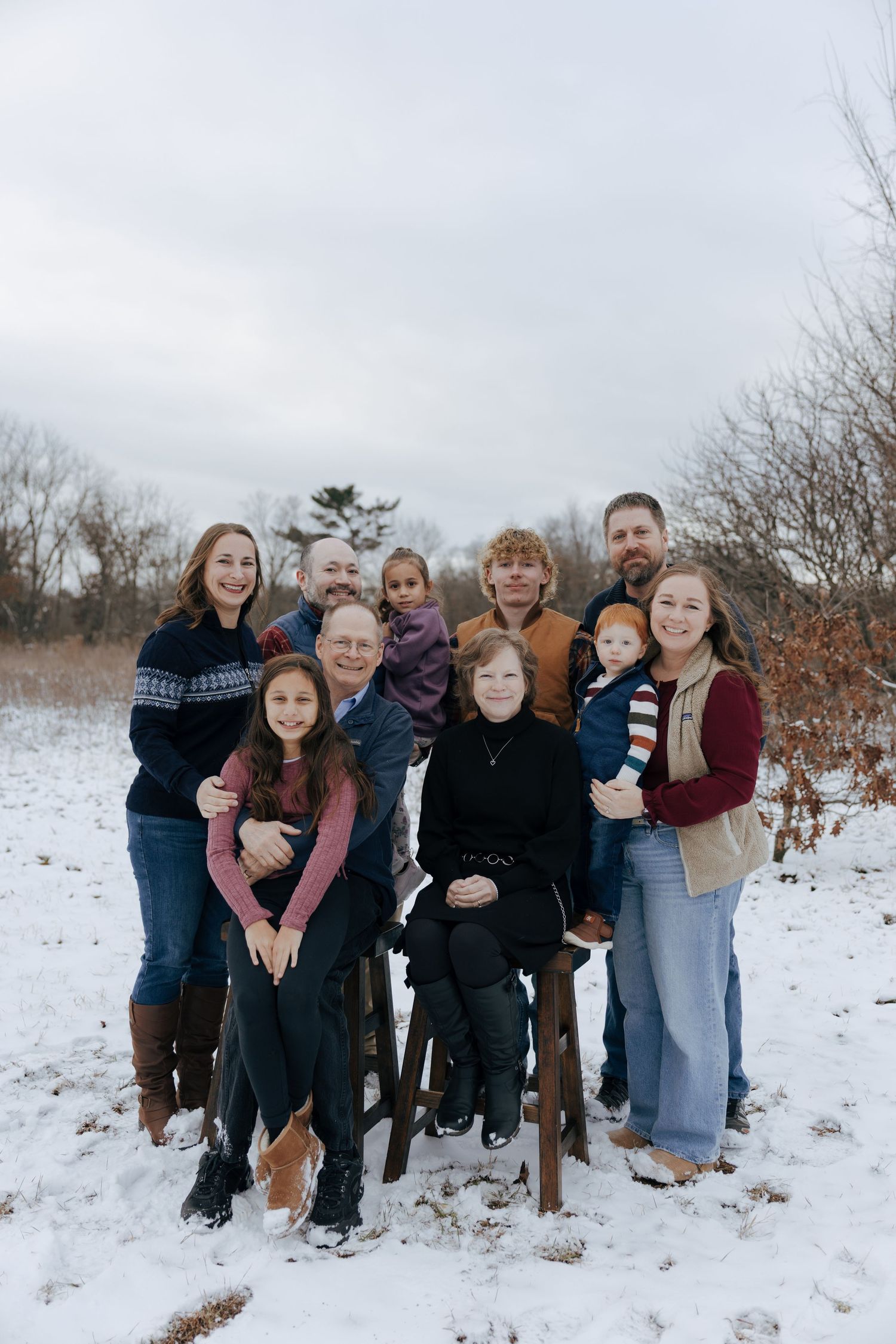 Candid family moment captured during sunset in a field.