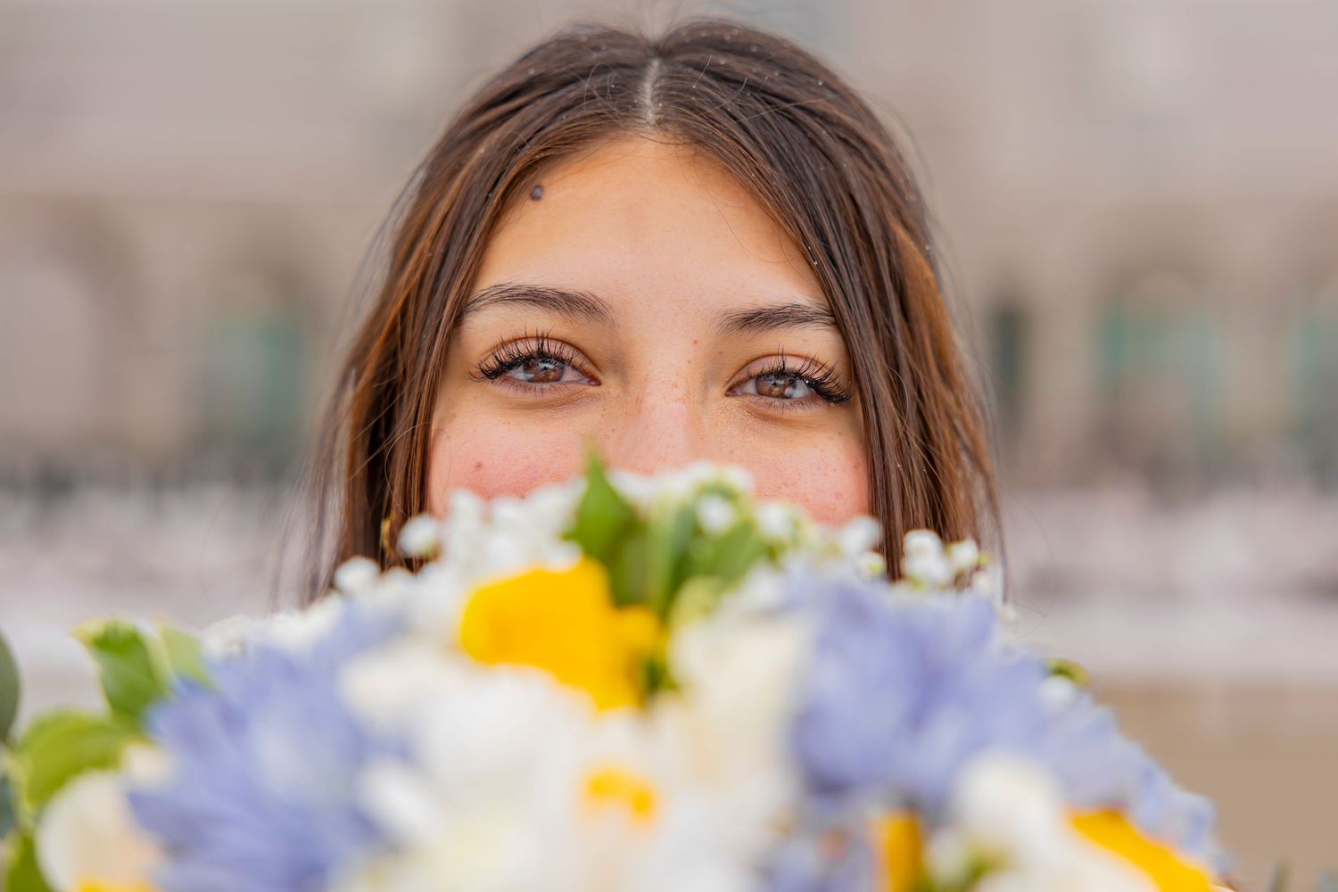Close-up of delicate blue and white floral wedding bouquet details.