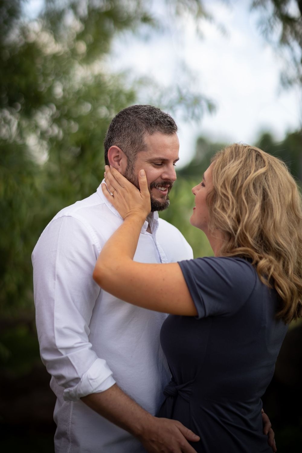 A couple shares intimate moments and embraces during an outdoor photo session.