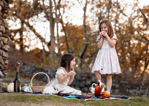 A series of outdoor lifestyle photos showing a picnic blanket and white dress in warm autumn lighting.