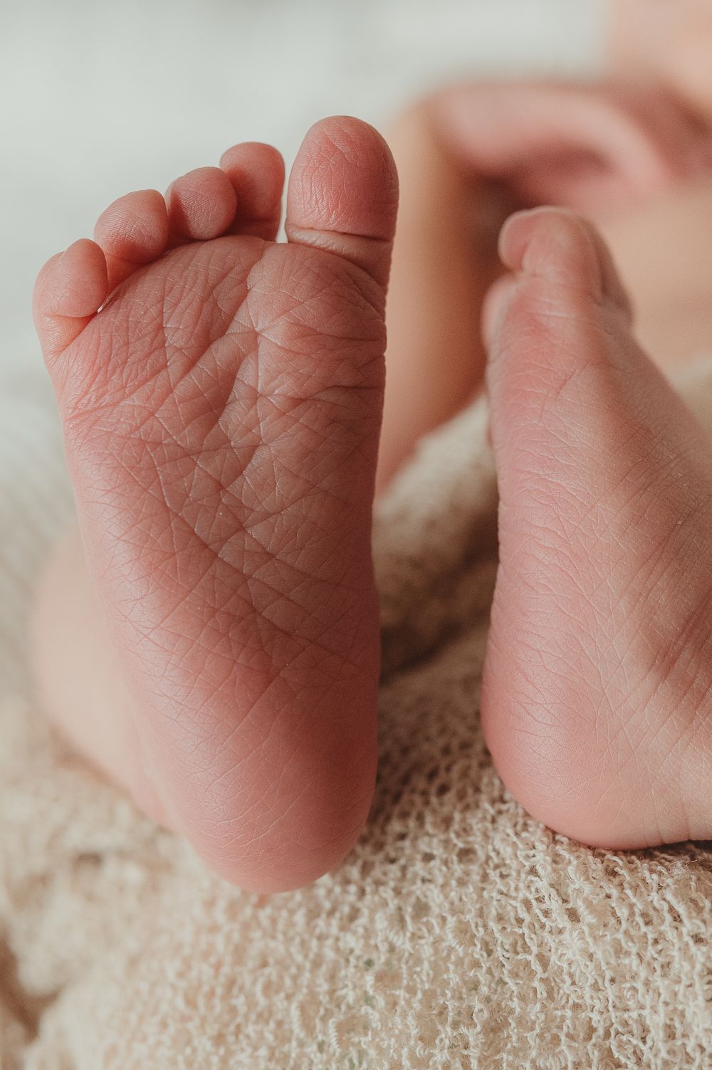 Close-up of newborn feet in a cozy home setting