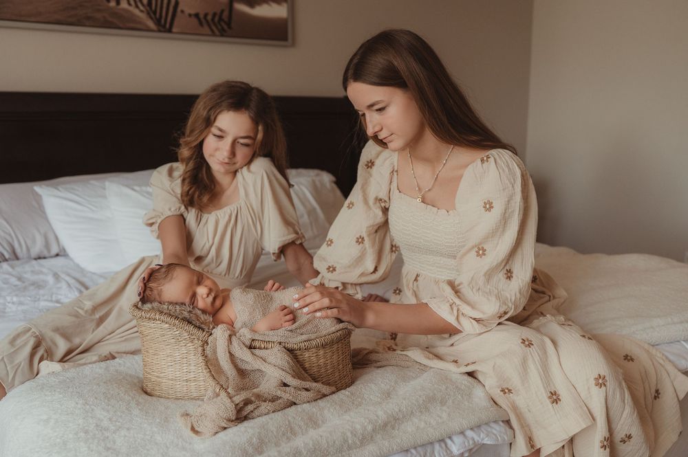 Newborn baby with siblings during a natural light lifestyle family photography session