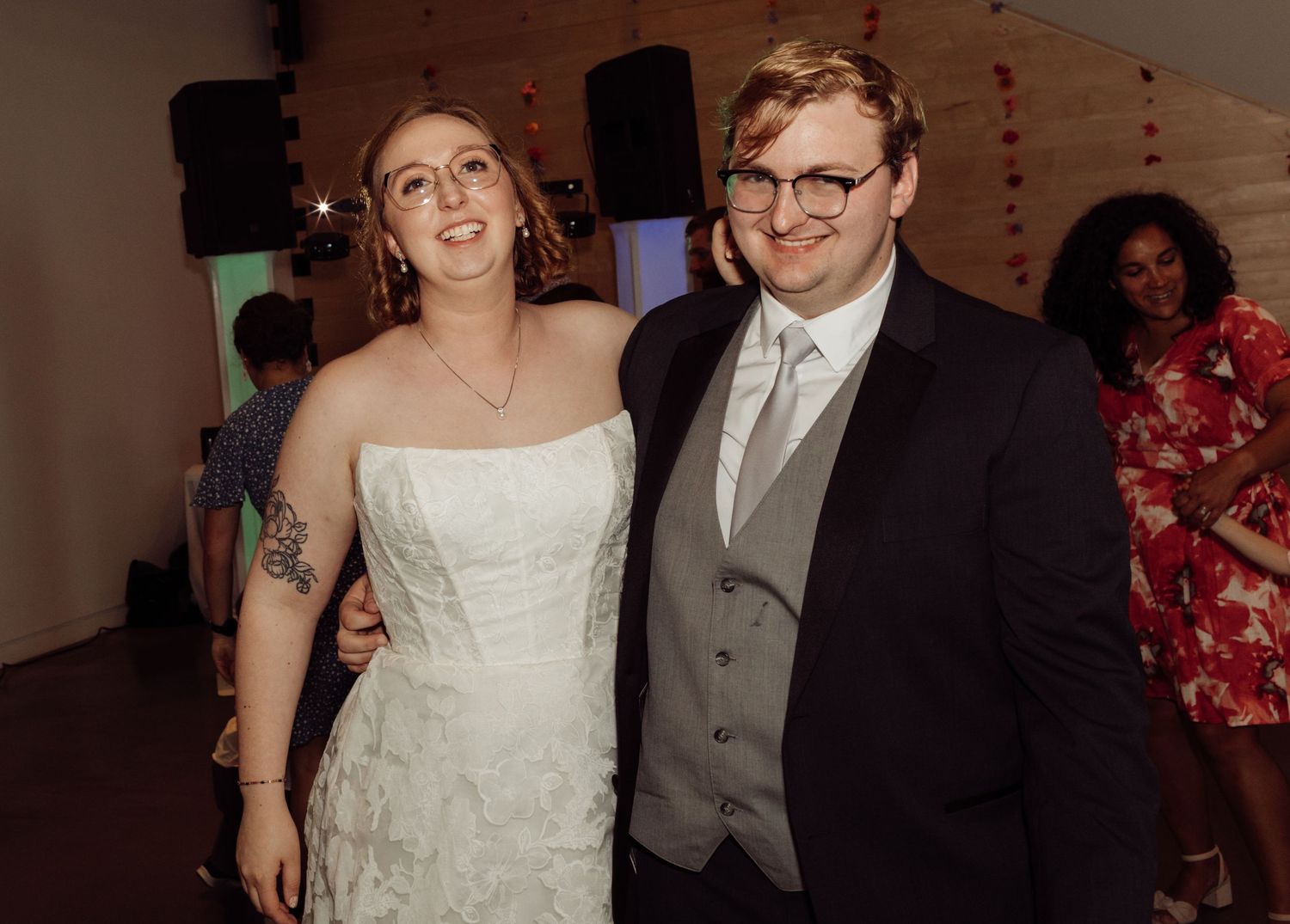 Smiling bride and groom posing together on the wedding reception dance floor.