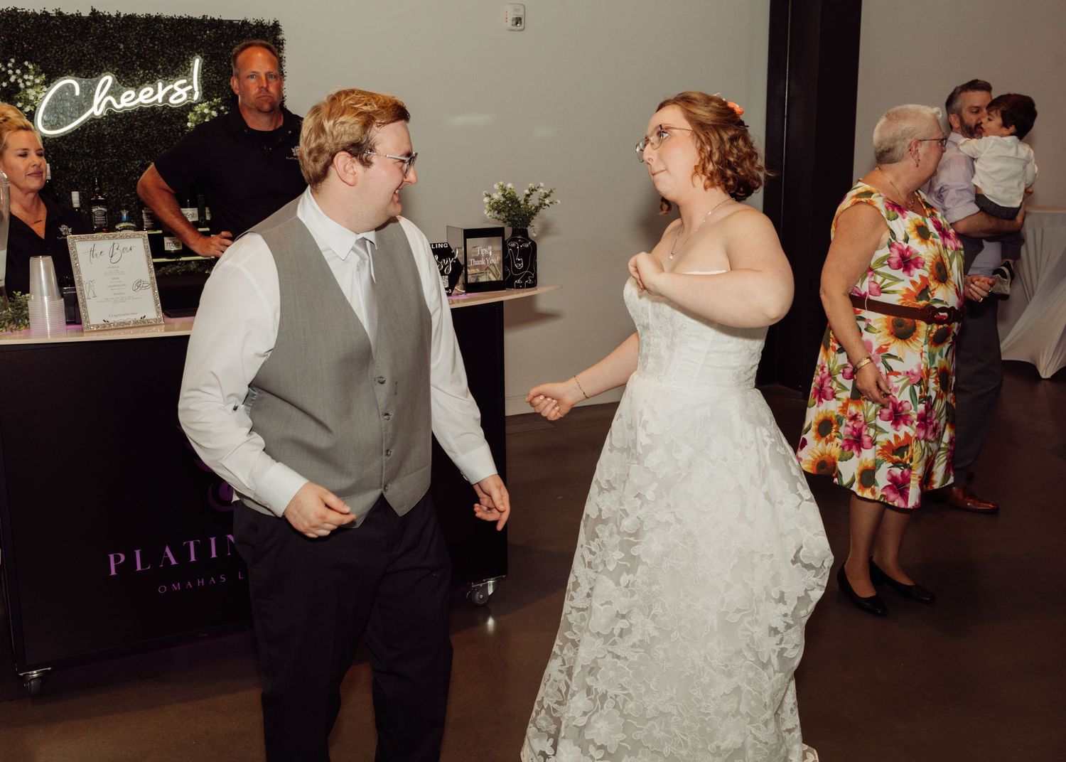 Bride and groom sharing a dance near the bar at their wedding reception.