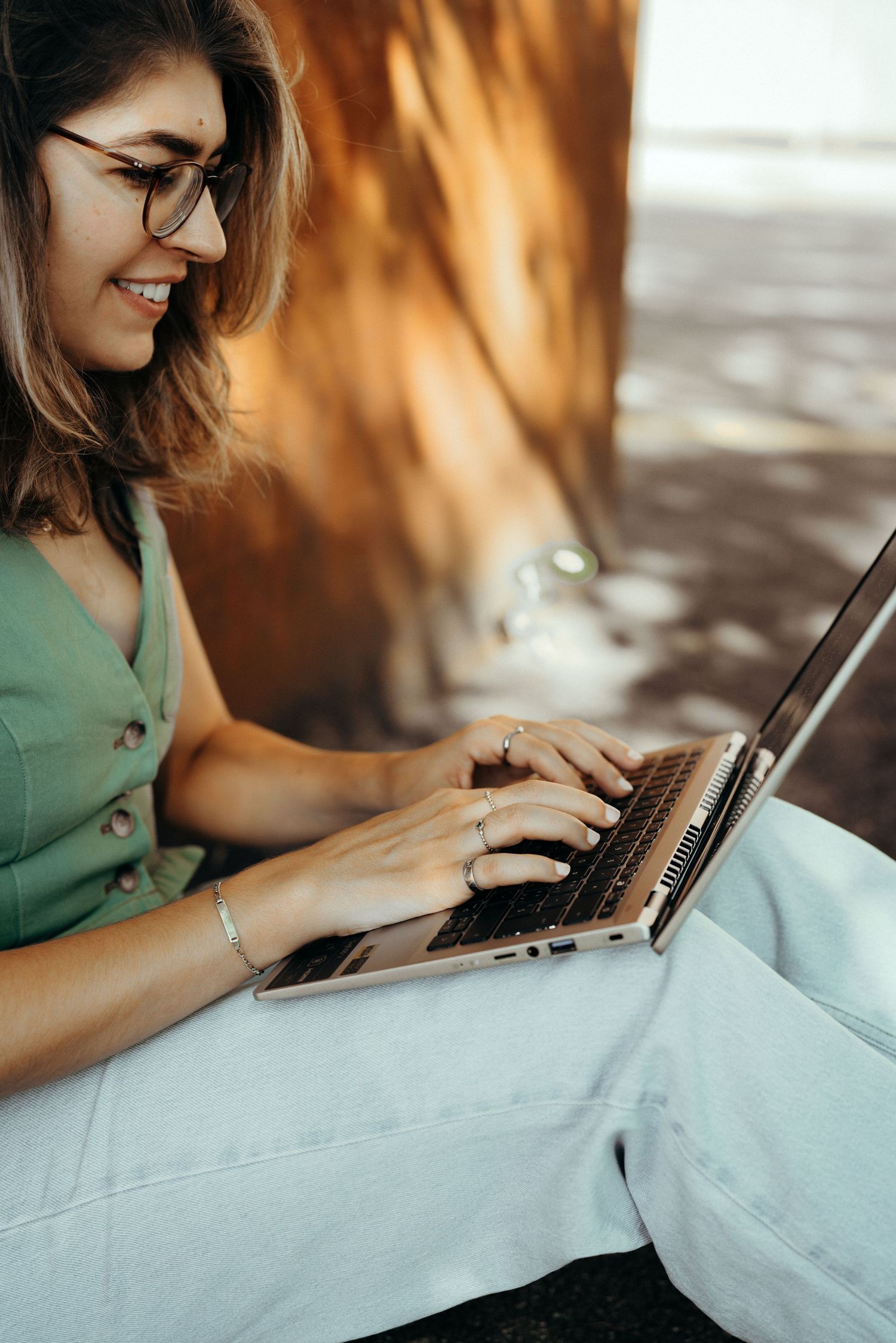 Book your photography session; Woman typing on her laptop.