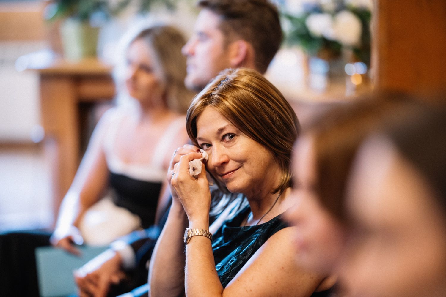 Guest wiping a tear during a Post Hotel wedding ceremony in Lake Louise
