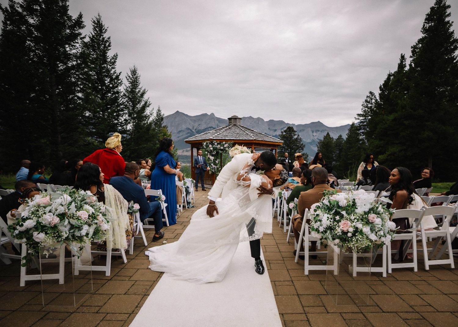 Couple exiting their ceremony at Silvertip Resort among white florals