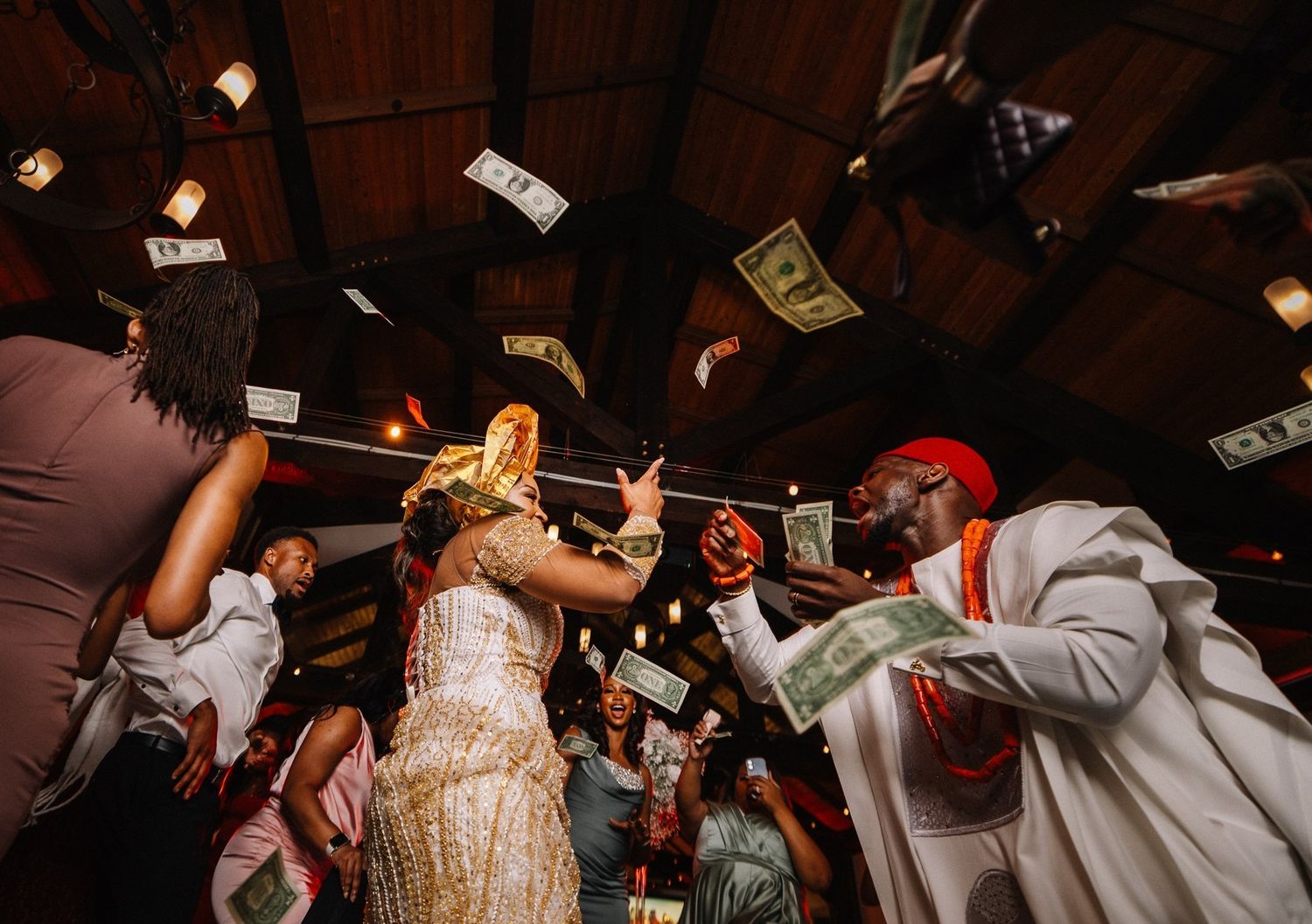 Joyful money spray dance on a packed reception dance floor, by a Calgary wedding photographer