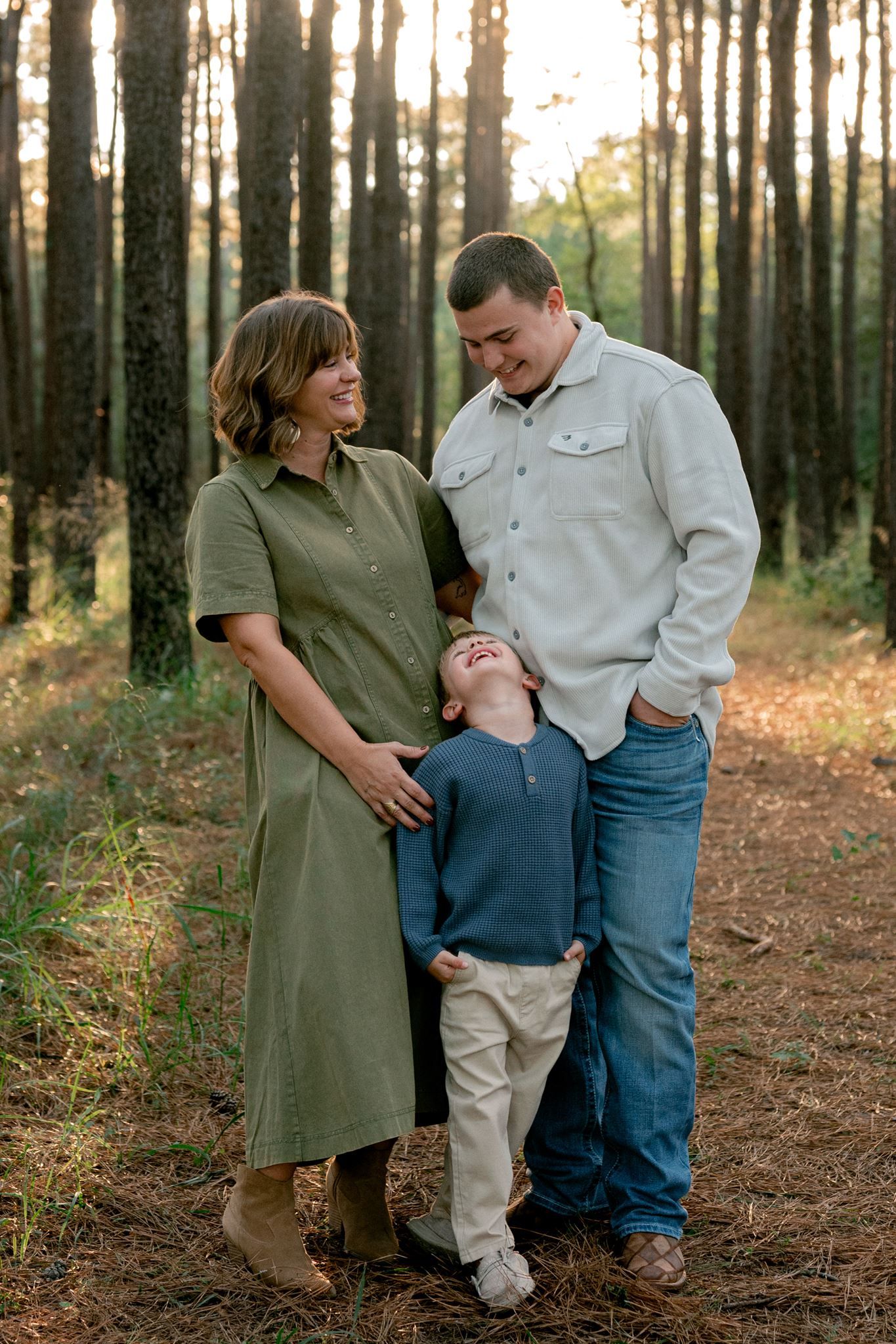 Natural outdoor family portraits with warm autumn outfits in The Woodlands area.