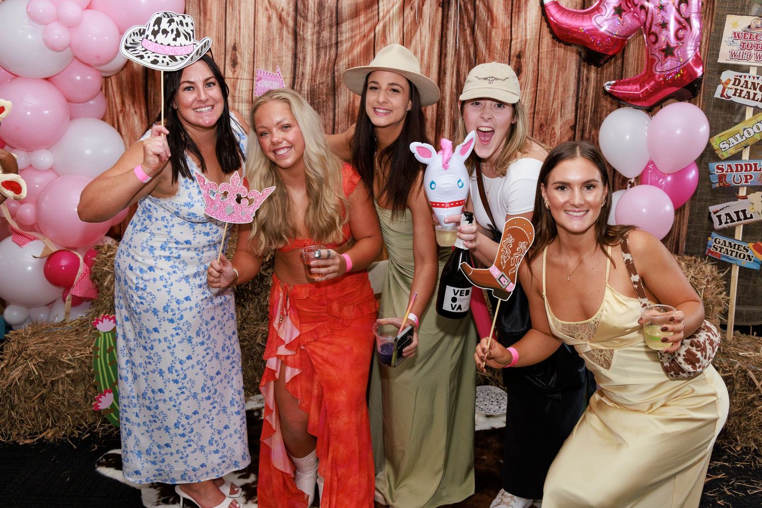 group of ladies having fun at a photo booth