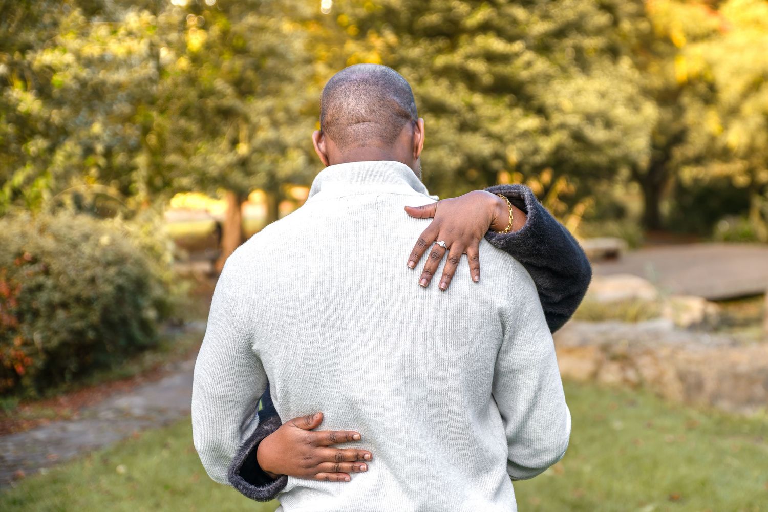 Sharing a romantic kiss after recent wedding proposal with engagement ring on display, Rotherham, Sheffield, South Yorkshire UK