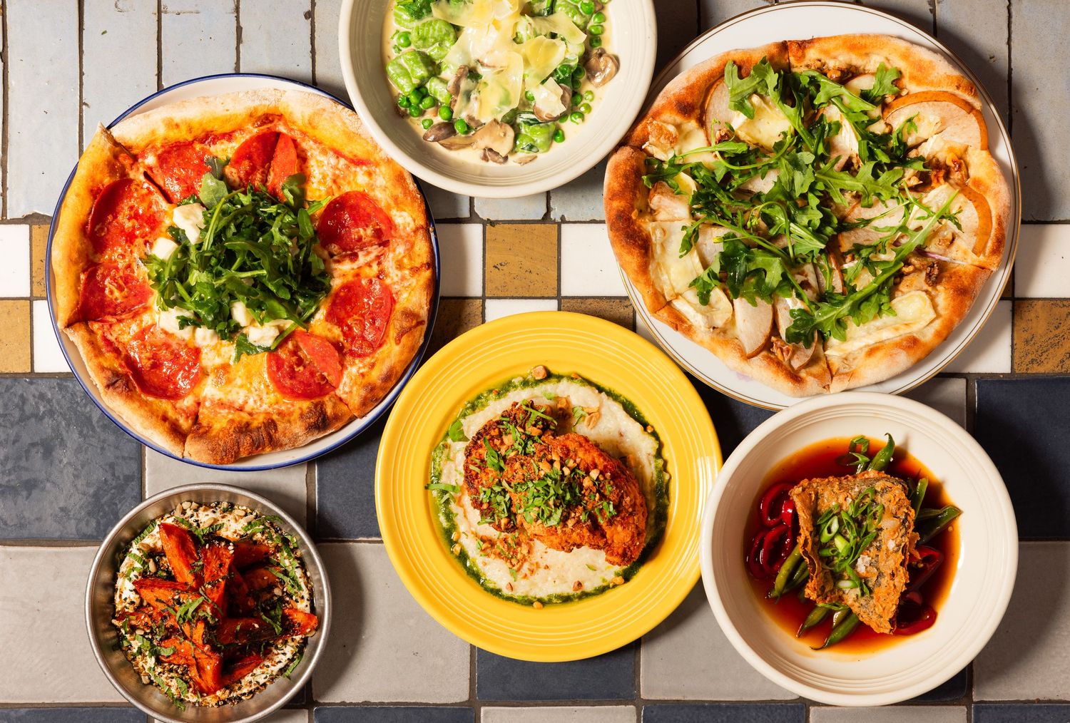 Overhead restaurant flat lay with multiple dishes