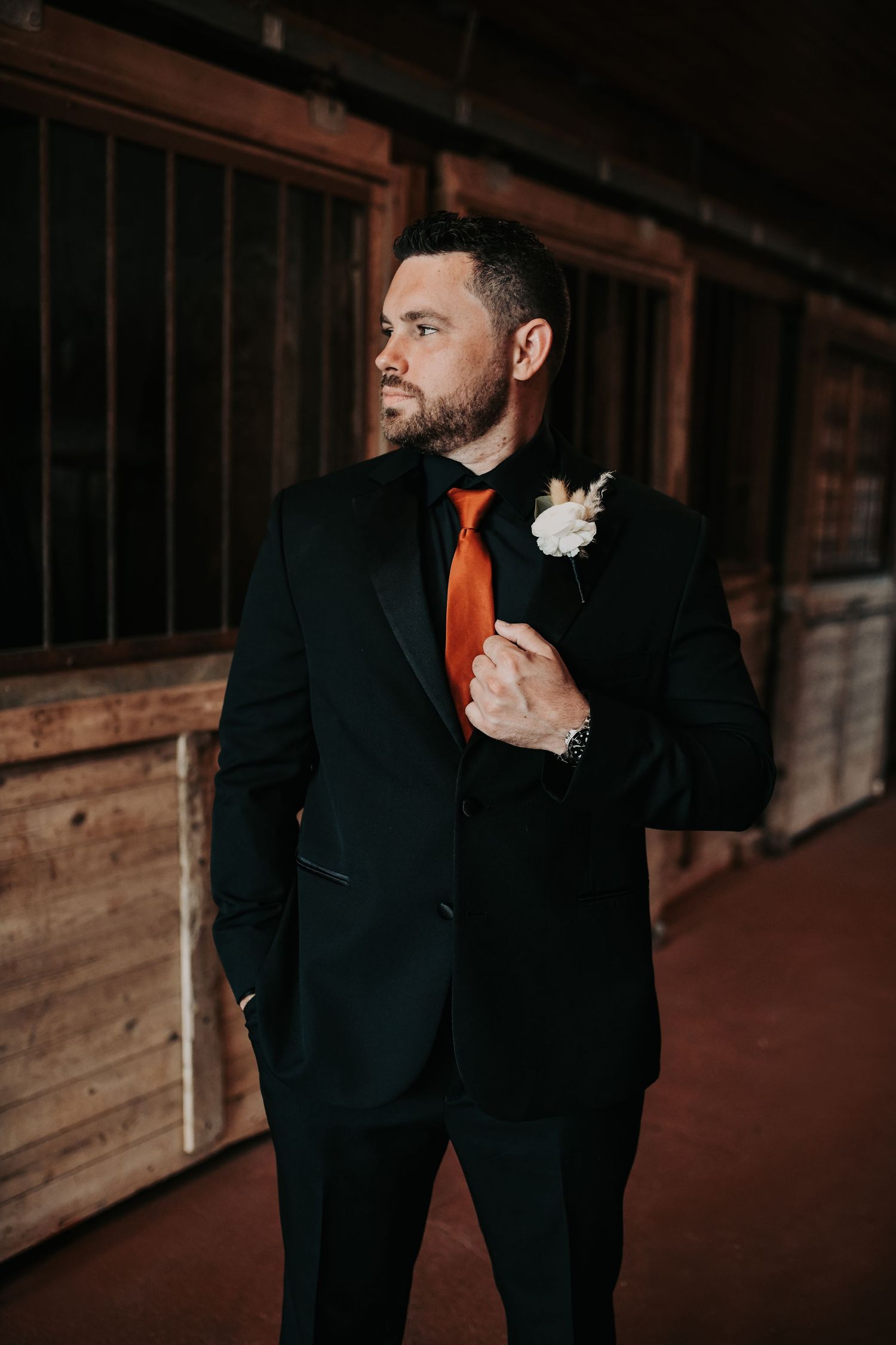 Groom getting ready inside the horse stalls at Lucky Spur Ranch
