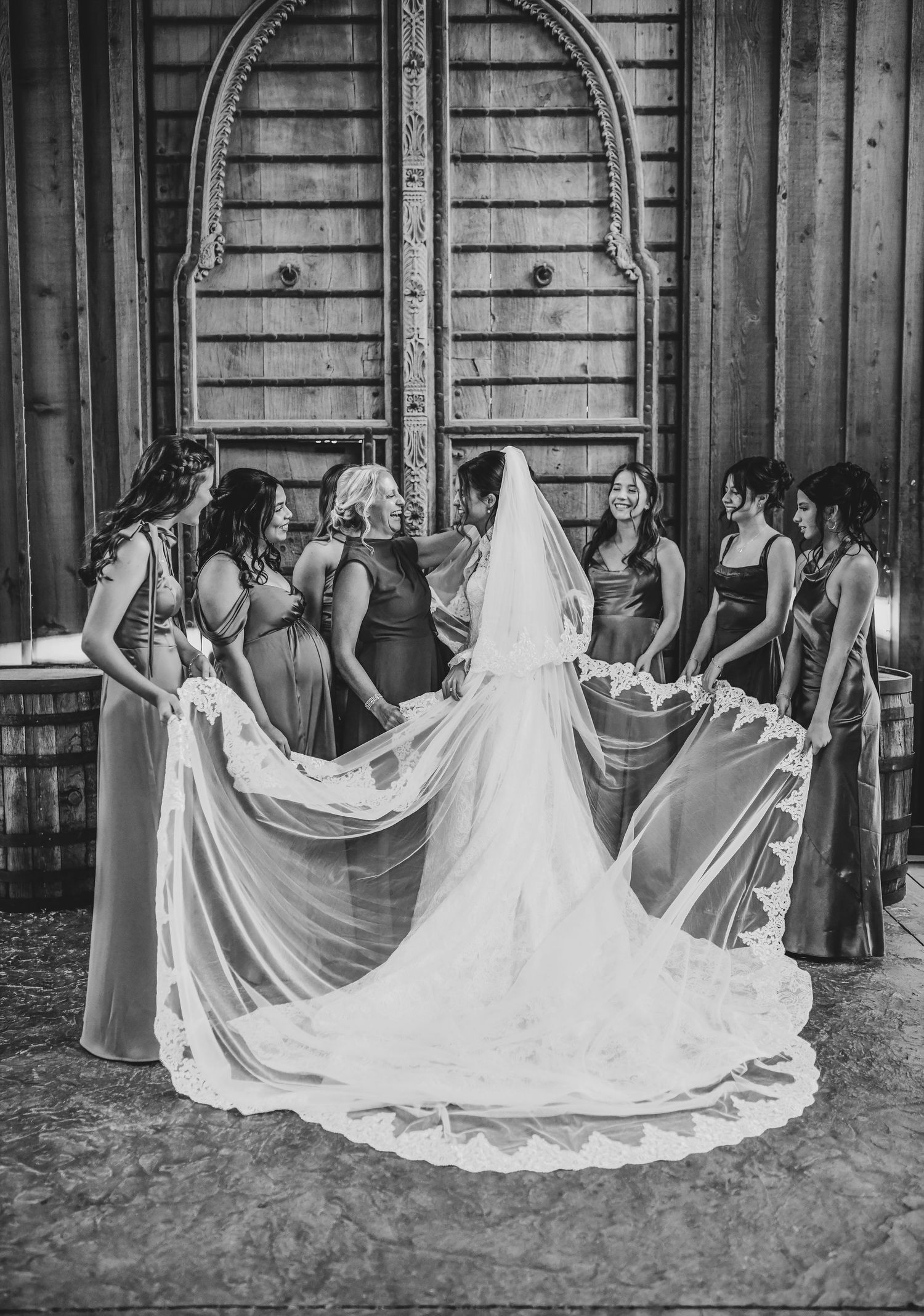 Bride getting dressed with bridesmaids before Catholic wedding ceremony