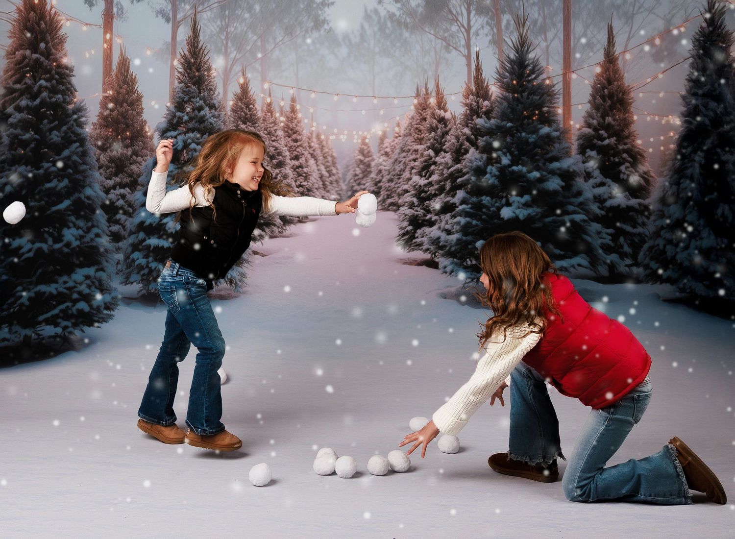 Two girls having a snowball fight in a snowy winter forest scene with pine trees and falling snow.