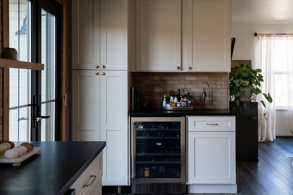 kitchen with cabinets and brick