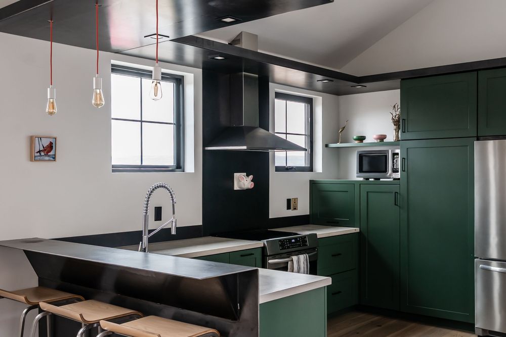 green kitchen with stainless steal fixtures