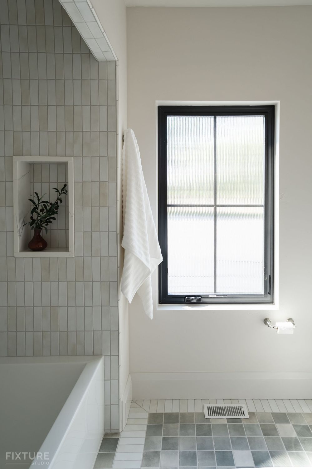 bathroom with colorful tile and window