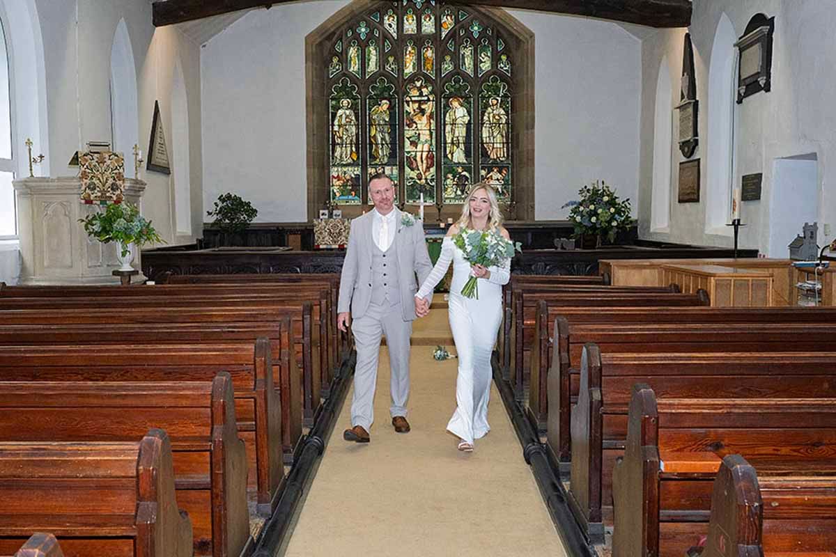 Jamie & Anna walk dow the aisle at their Lake District elopement wedding