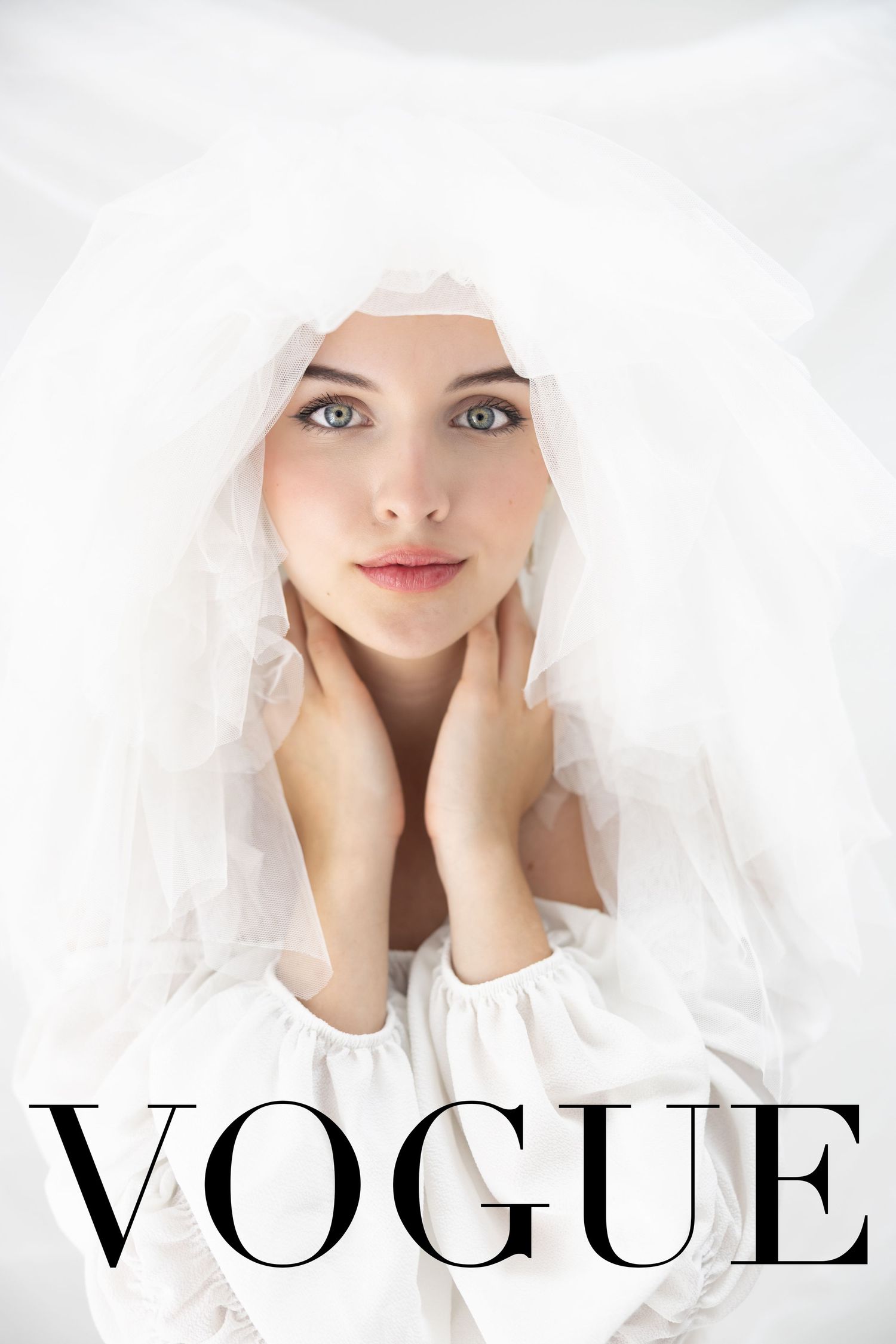 Young bride in white veil and dress poses gracefully for Vogue magazine cover, showcasing elegant bridal fashion.