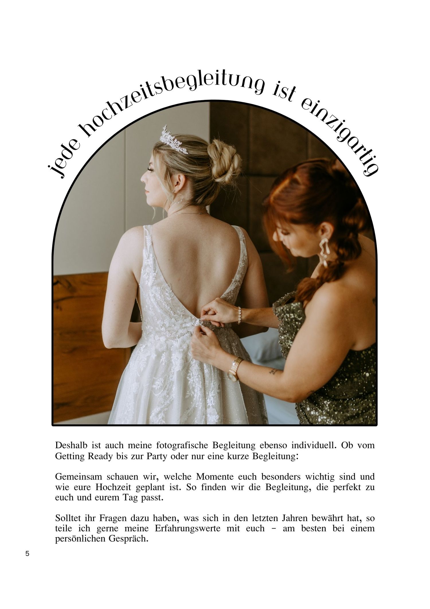 A bride in a white lace gown gets her dress fastened by a redheaded woman in a warmly lit bridal preparation scene.