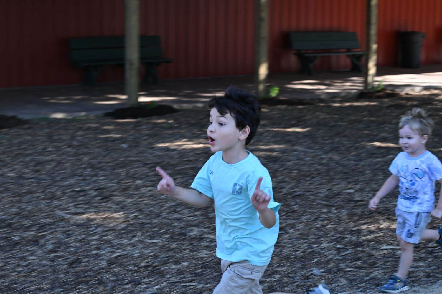 Children running and playing outdoors during a candid family adventure.