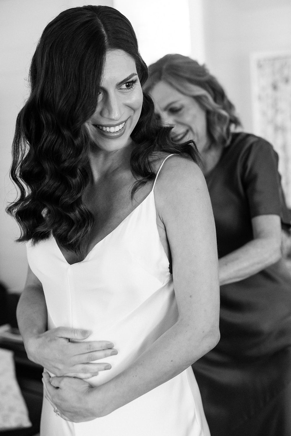 A series of tender black and white moments showing affection in a white dress.
