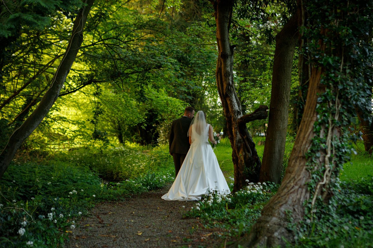bride-groom-walking-woodland-mitton-hall-lancashire-wedding-photo-jane-ball-photography