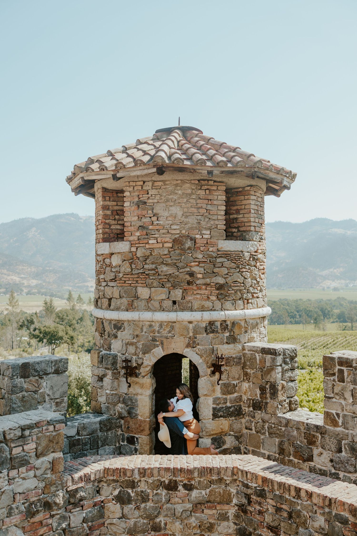 candid engagement couple at castello di amorosa winery in napa california