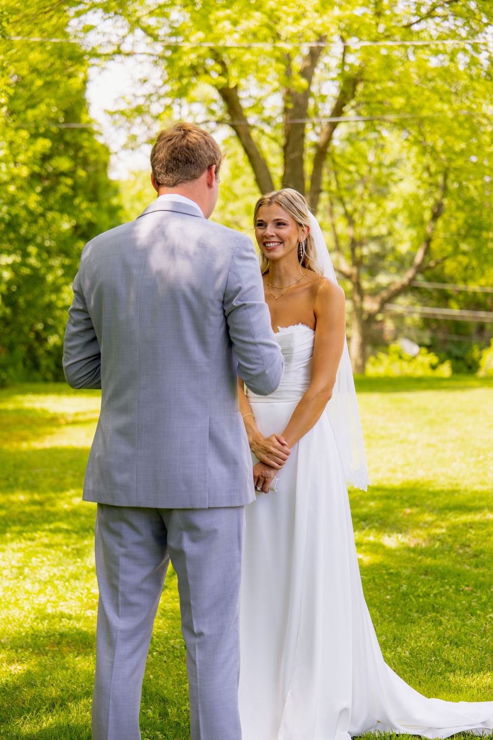 A bride smiles at her groom