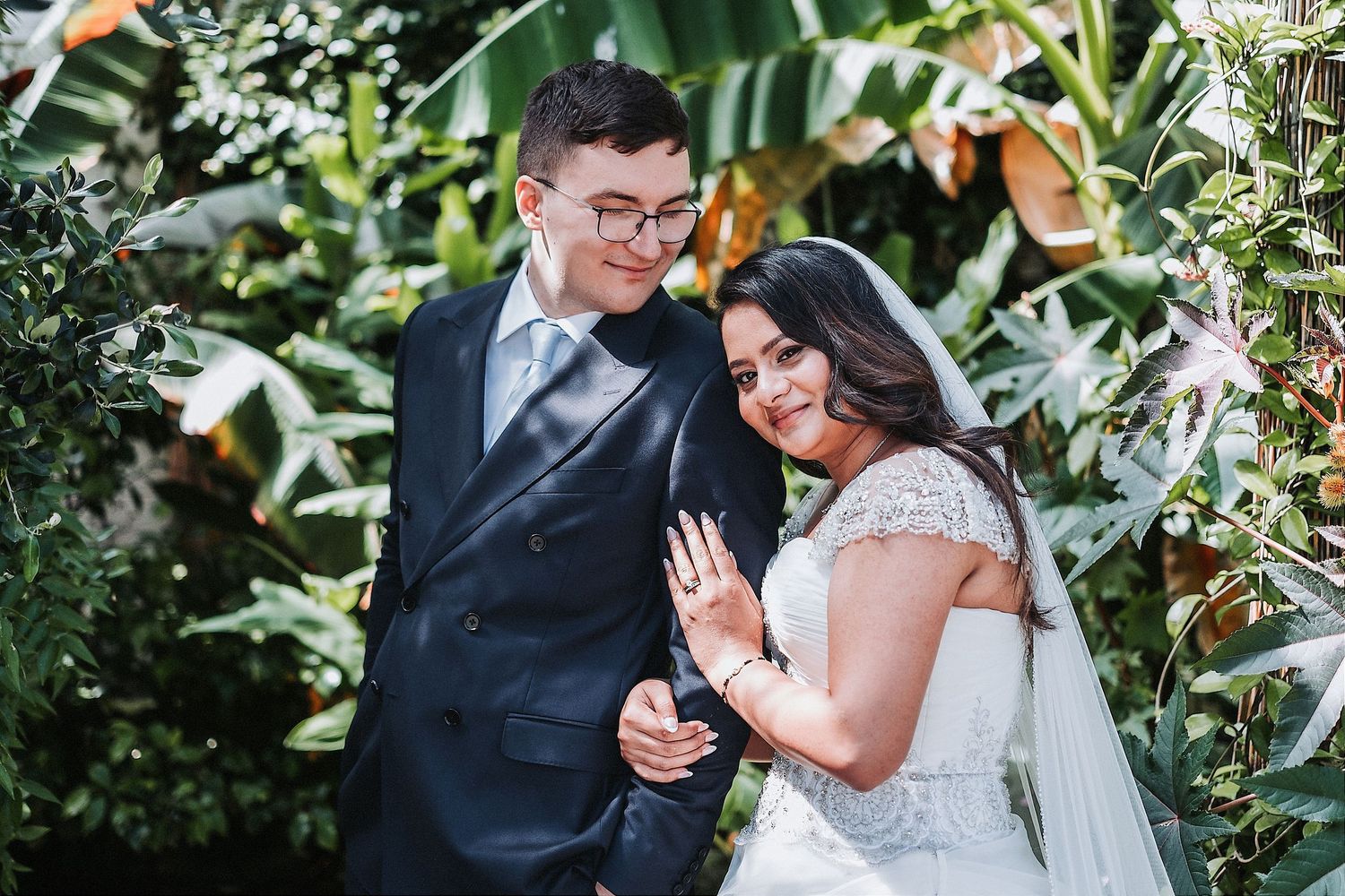 Elegant wedding bouquets featuring blush roses and greenery alongside formal attire.