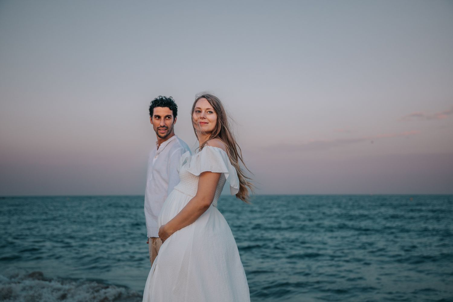 Tender afternoon couple photoshoot at Poble Nou beach Barcelona, enjoying a quiet Mediterranean sunset walk with privacy.