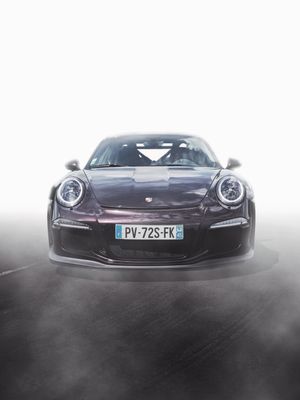 Dark purple Porsche 911 GT3 RS sports car front view on track with French license plate PV-72S-FK.