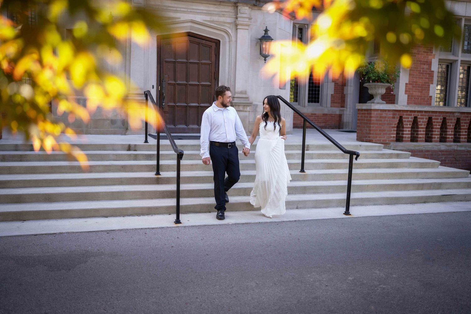 engaged couple posing romantically on stone steps in columbus ohio