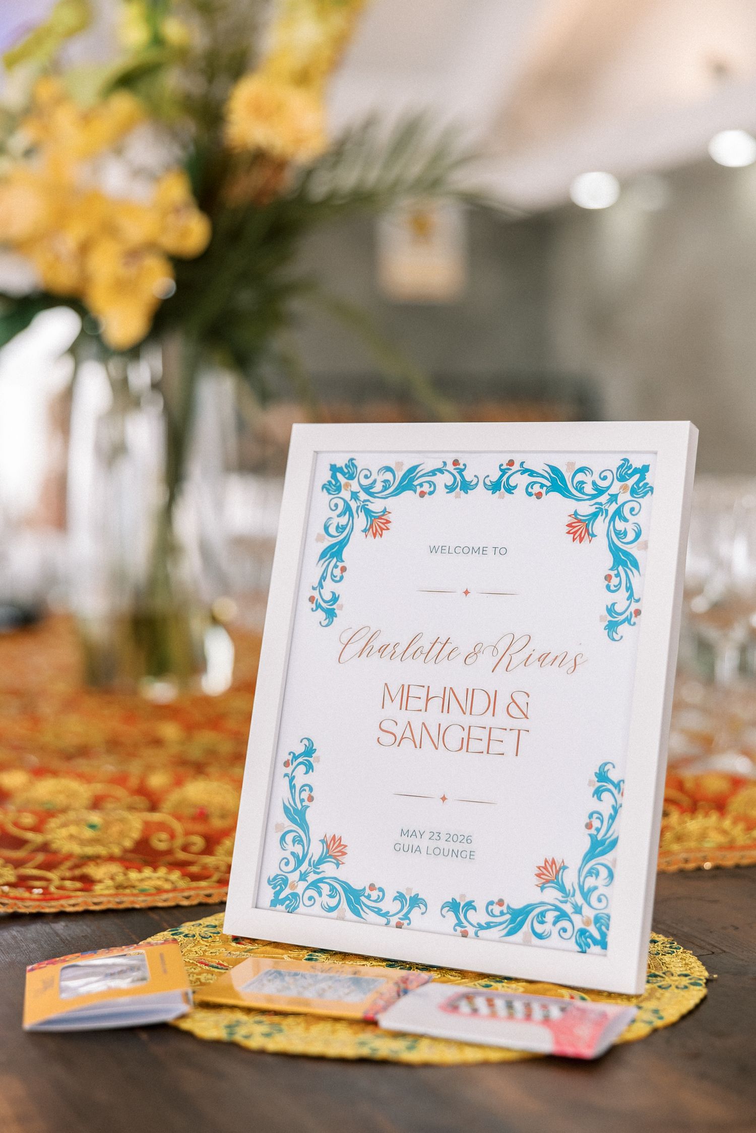 Mehndi and Sangeet welcome sign and colourful decor for an Indian destination wedding in Portugal.