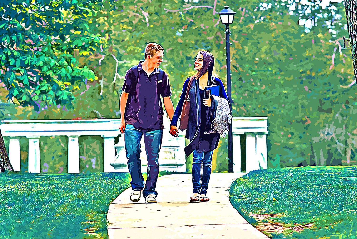 A couple holds hands while walking along a scenic park pathway surrounded by lush green trees and a white bridge.