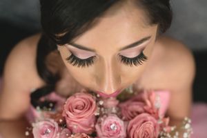 Artistic close-up shots with pink roses and dramatic eyelashes.