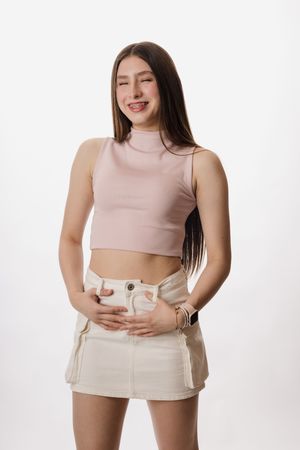 Fashion photography series featuring neutral toned crop top and white denim styling.