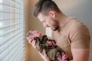 Family relaxing on sofa with newborn baby - Lifestyle newborn session by Gesiel Martins in Rochester Hills, MI
