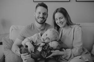 Family relaxing on sofa with newborn baby - Lifestyle newborn session by Gesiel Martins in Rochester Hills, MI