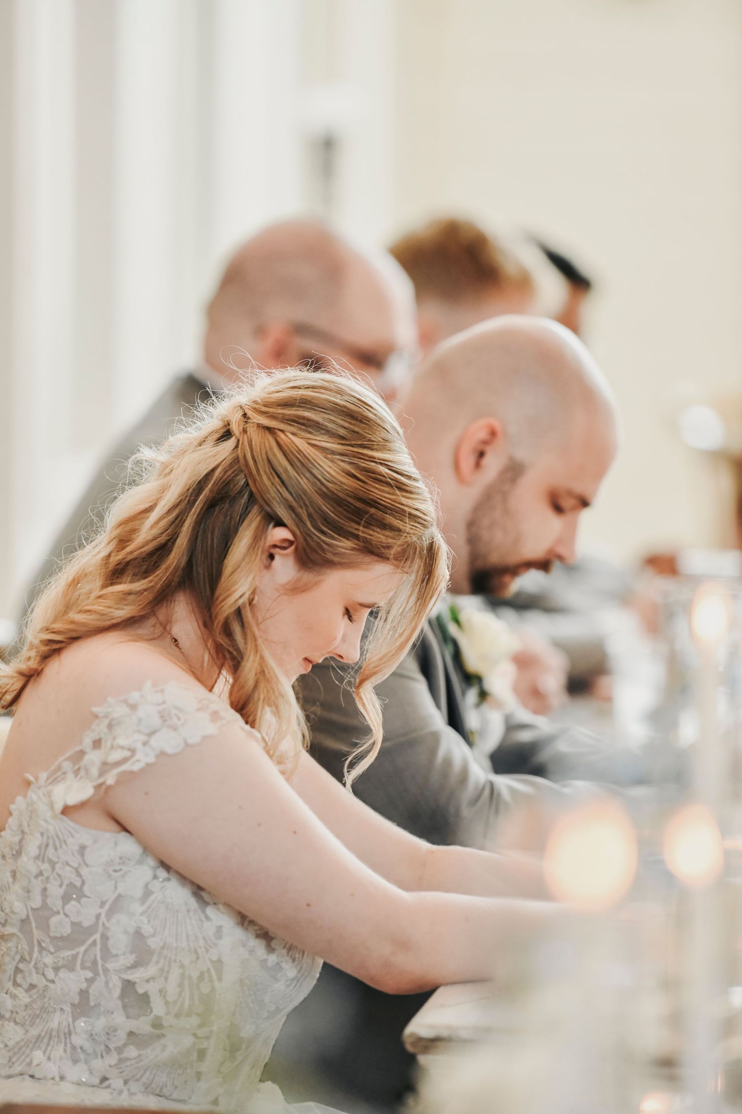 bride prays  with her groom