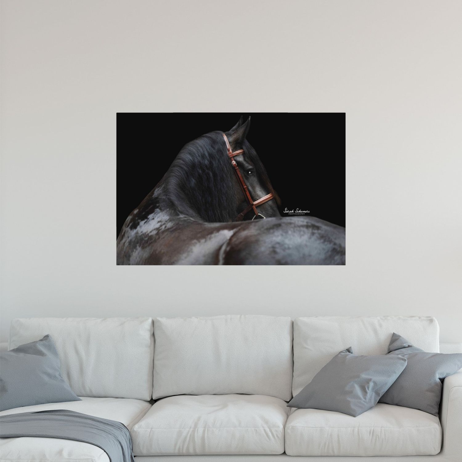 Rustic home office with wood desk and gallery wall of eight framed equestrian portrait photos in natural tones.