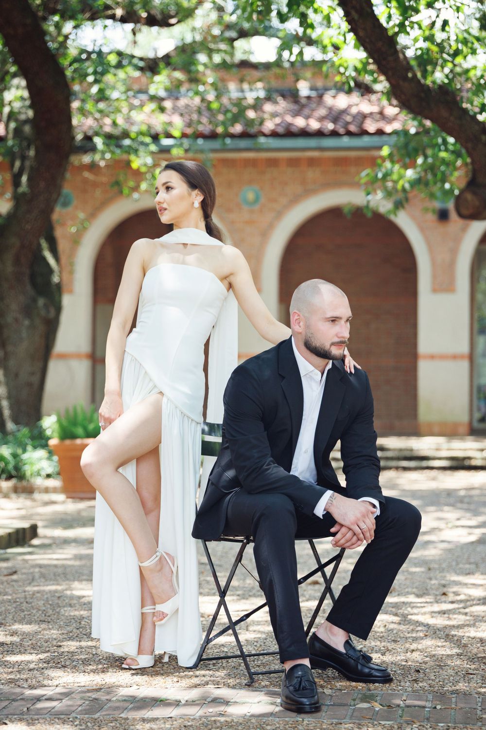 Bride and groom under the arches at Rice University