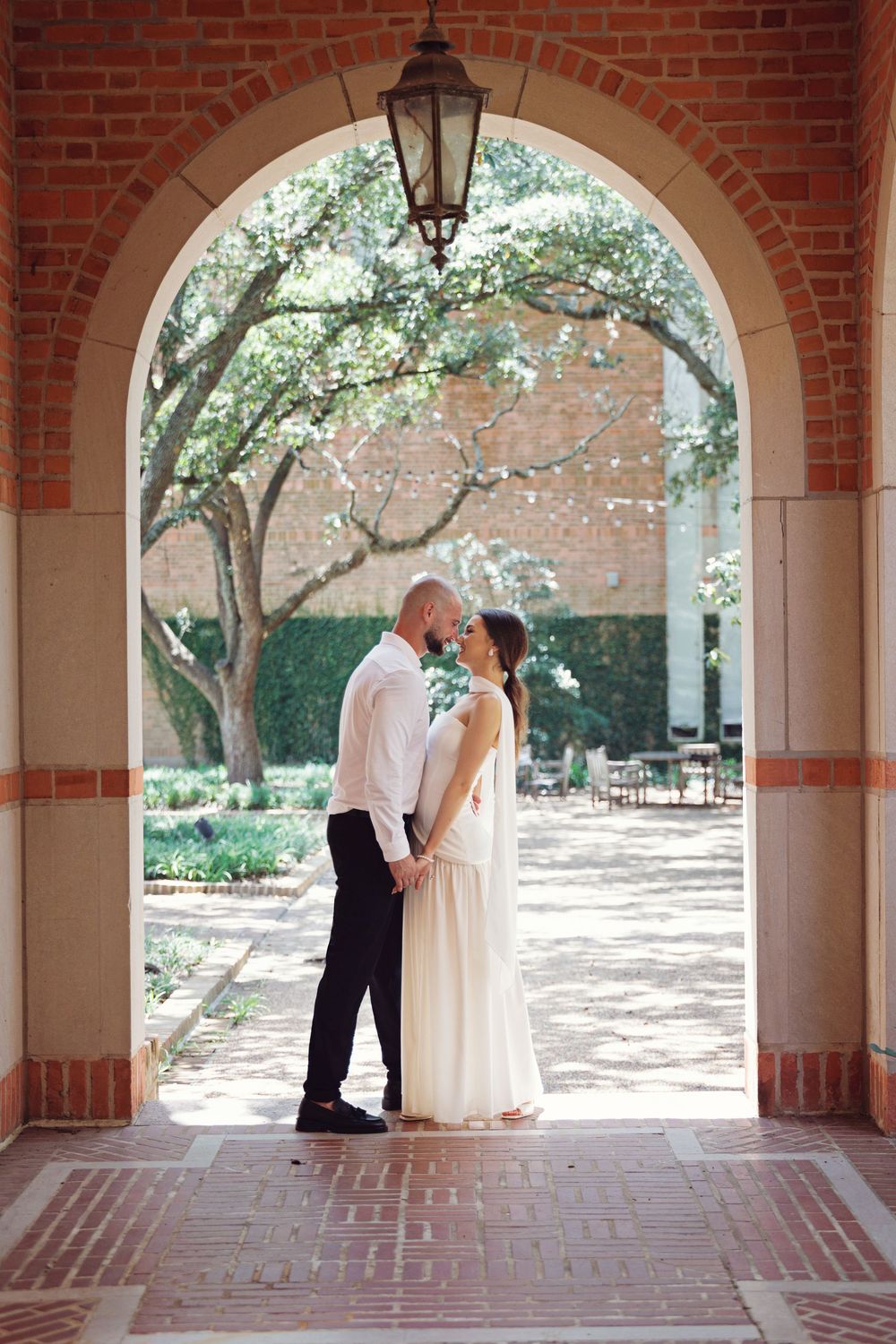 Bride and groom walking through Rice University campus