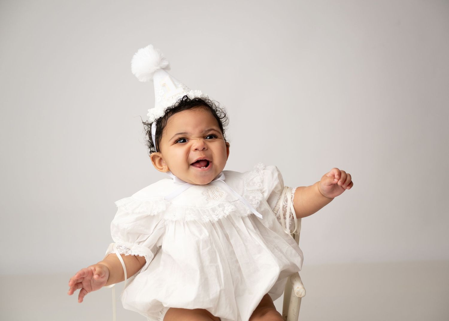 Smiling child during a milestone portrait session in a New Jersey photography studio.
