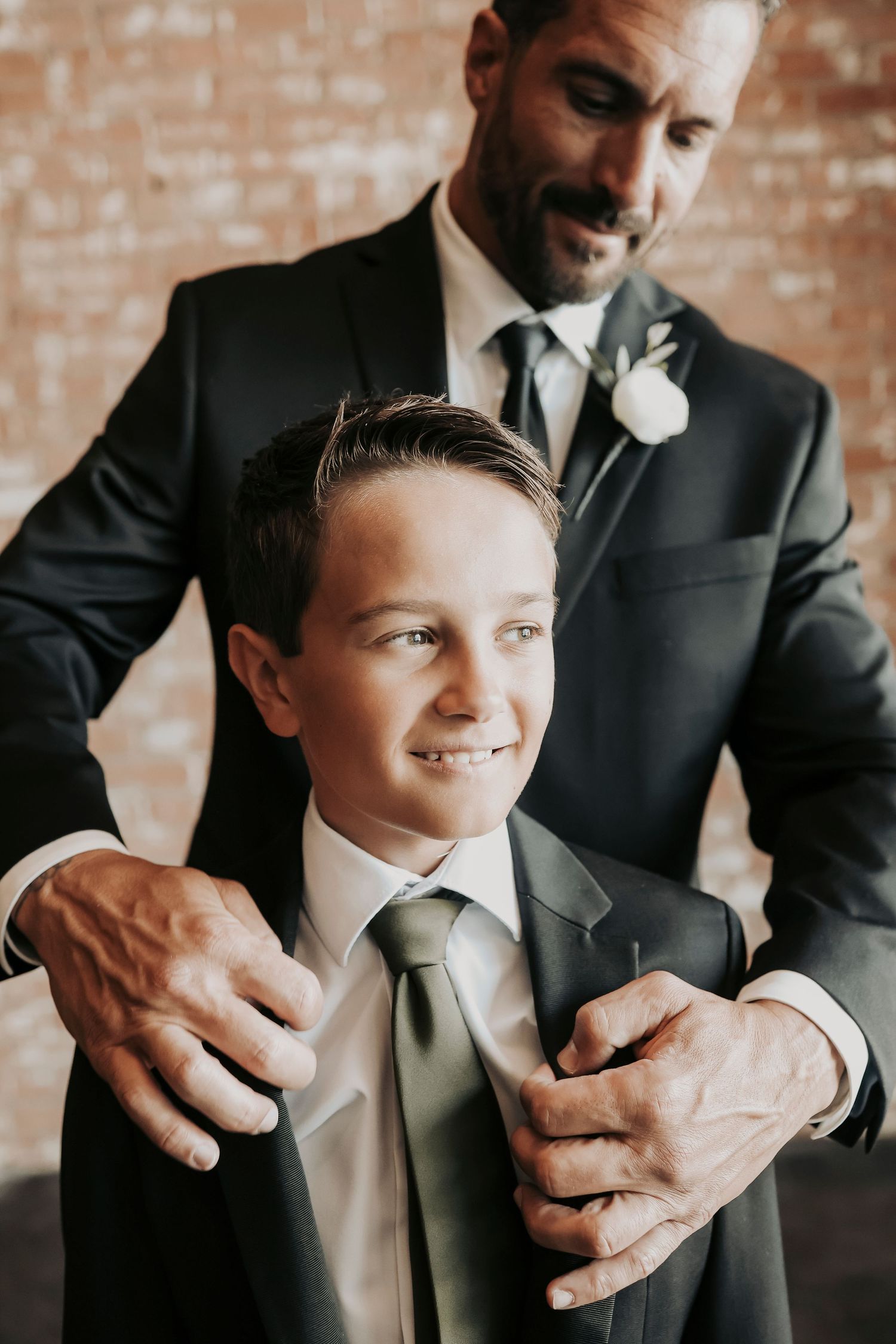 Joel sharing a fun wedding morning moment with his son