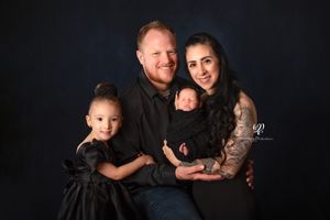 Family photo on black & wearing black; Mom, Dad, Sister, newborn; newborn photoshoot; best photographer Lexington, SC