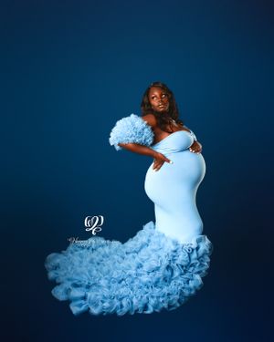 Black pregnant woman fine art maternity photoshoot session Lexington, SC; professional portrait studio; blue dress & blue studio backdrop