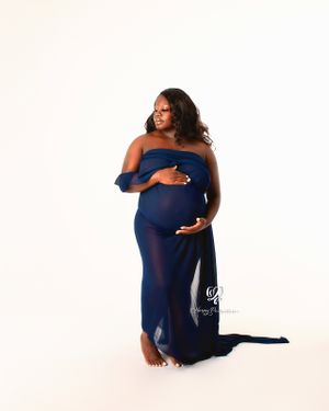 Stunning black woman posed with fabric close to body Maternity photoshoot professional portrait studio Lexington, SC; fine art photography