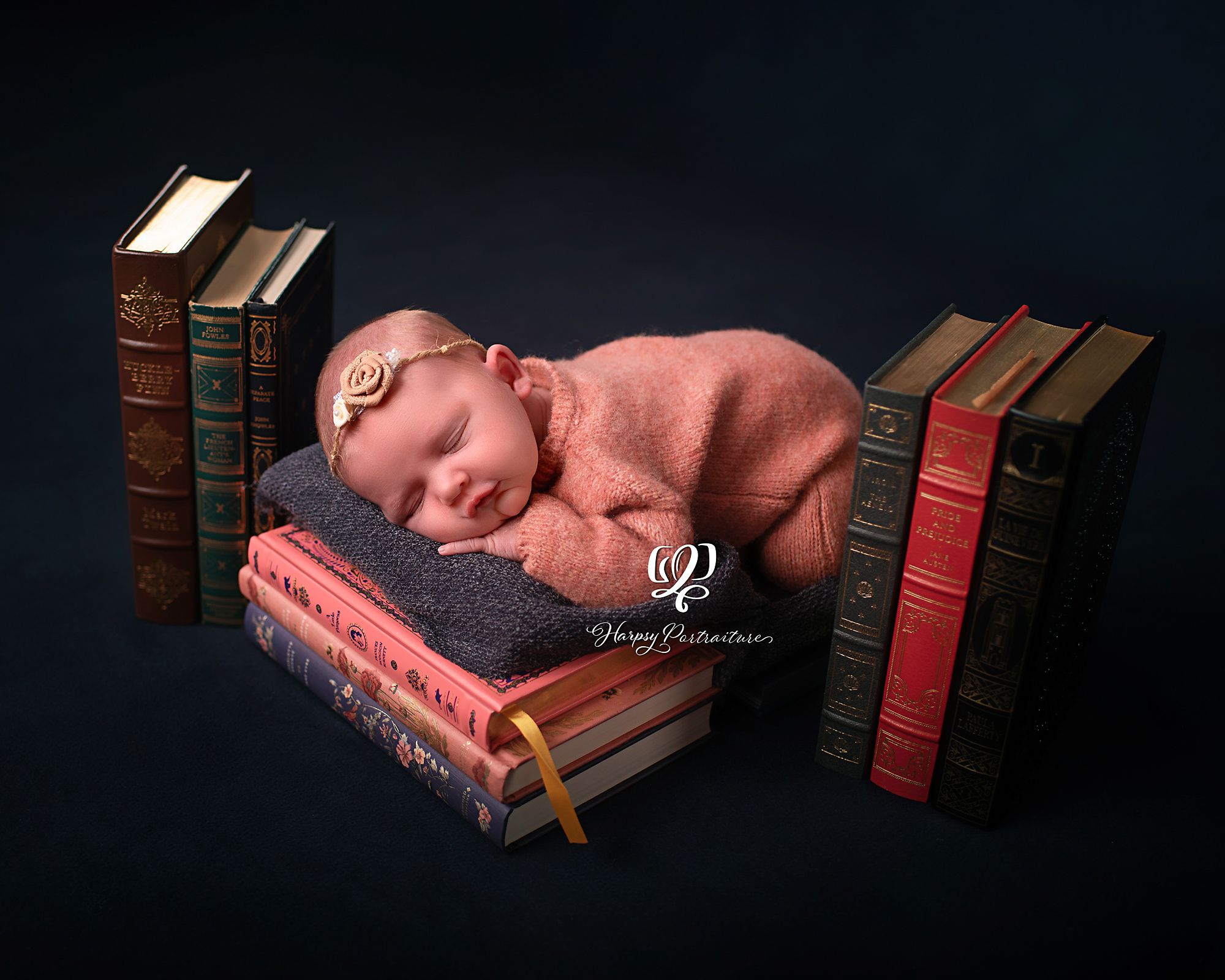newborn photo baby girl posed sleeping on vintage antique books; best photographer Lexington, SC; newborn photographer South Carolina